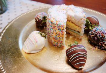 birthday cake and strawberries on platter e