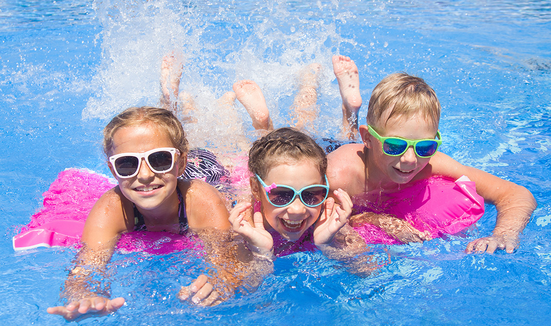 Children play in swimming  pool at the sea resort