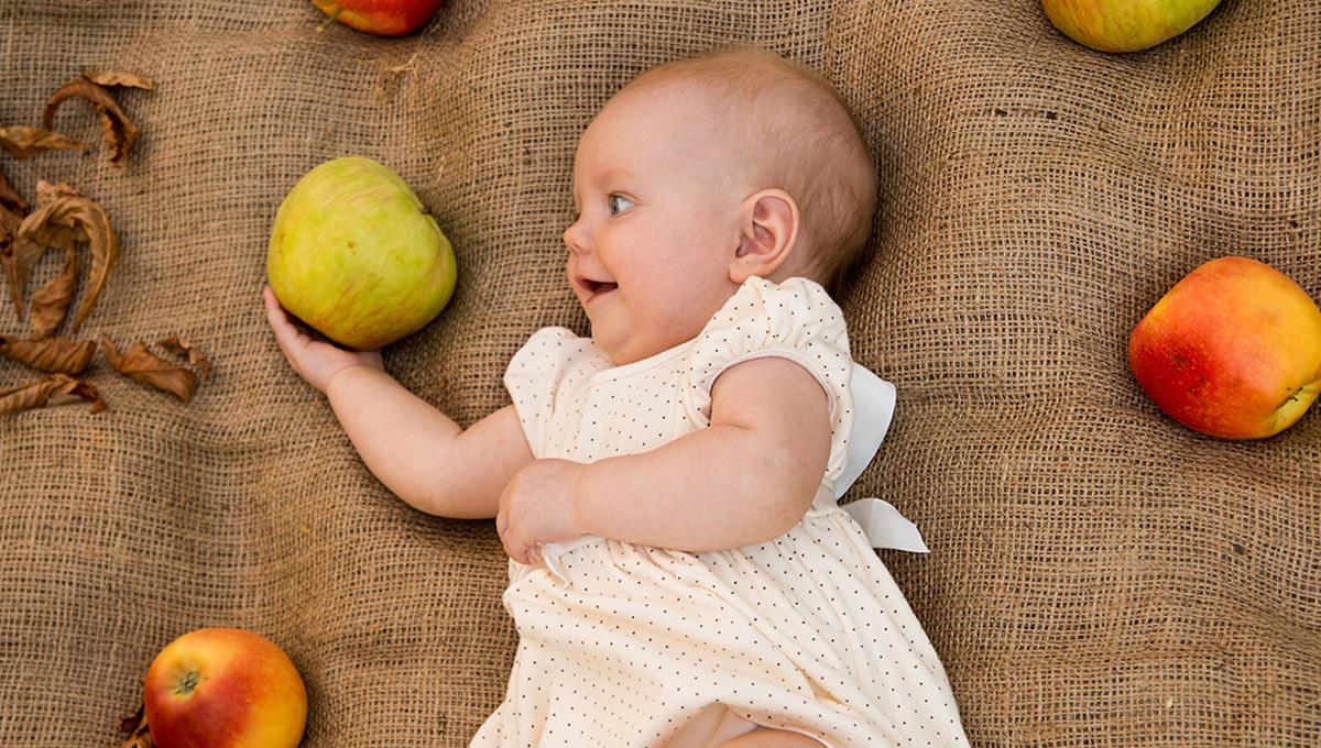 Cute baby girl with apples