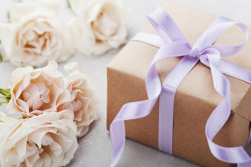 wedding gift etiquette gift in a box tied with a lavender bow.