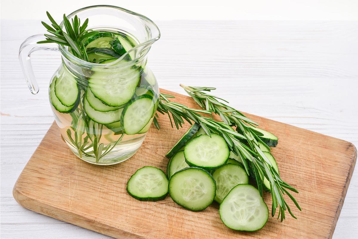 water with cucumber and herbs