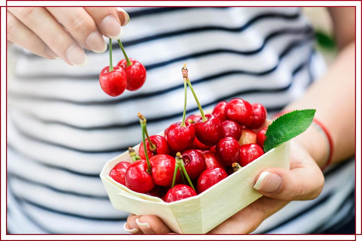 woman holding cherries