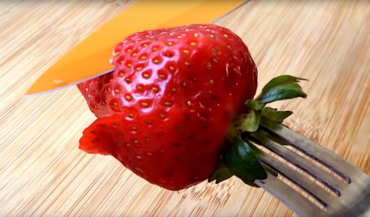 cutting strawberry petals