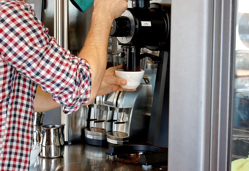 Coffee grinder grinding beans