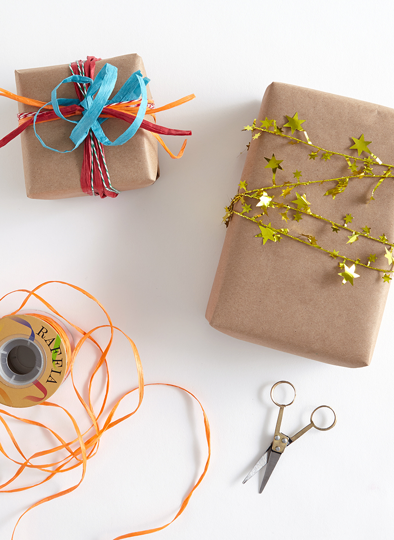 gold star tinsel garland wrapped around brown wrapping paper